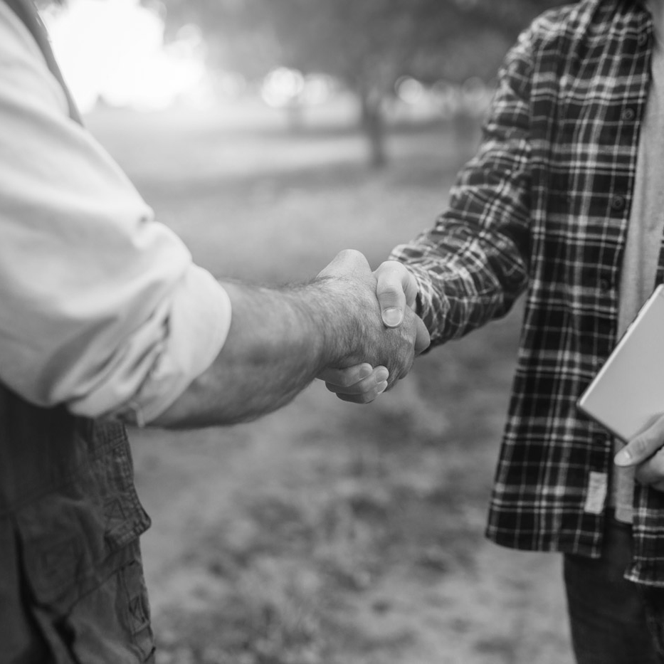 black and white photo of two men shaking hands